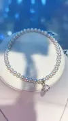 A white pearl bracelet paired with a silver diamond-encrusted spherical pendant and glass titanium steel crystal jewelry Specification image